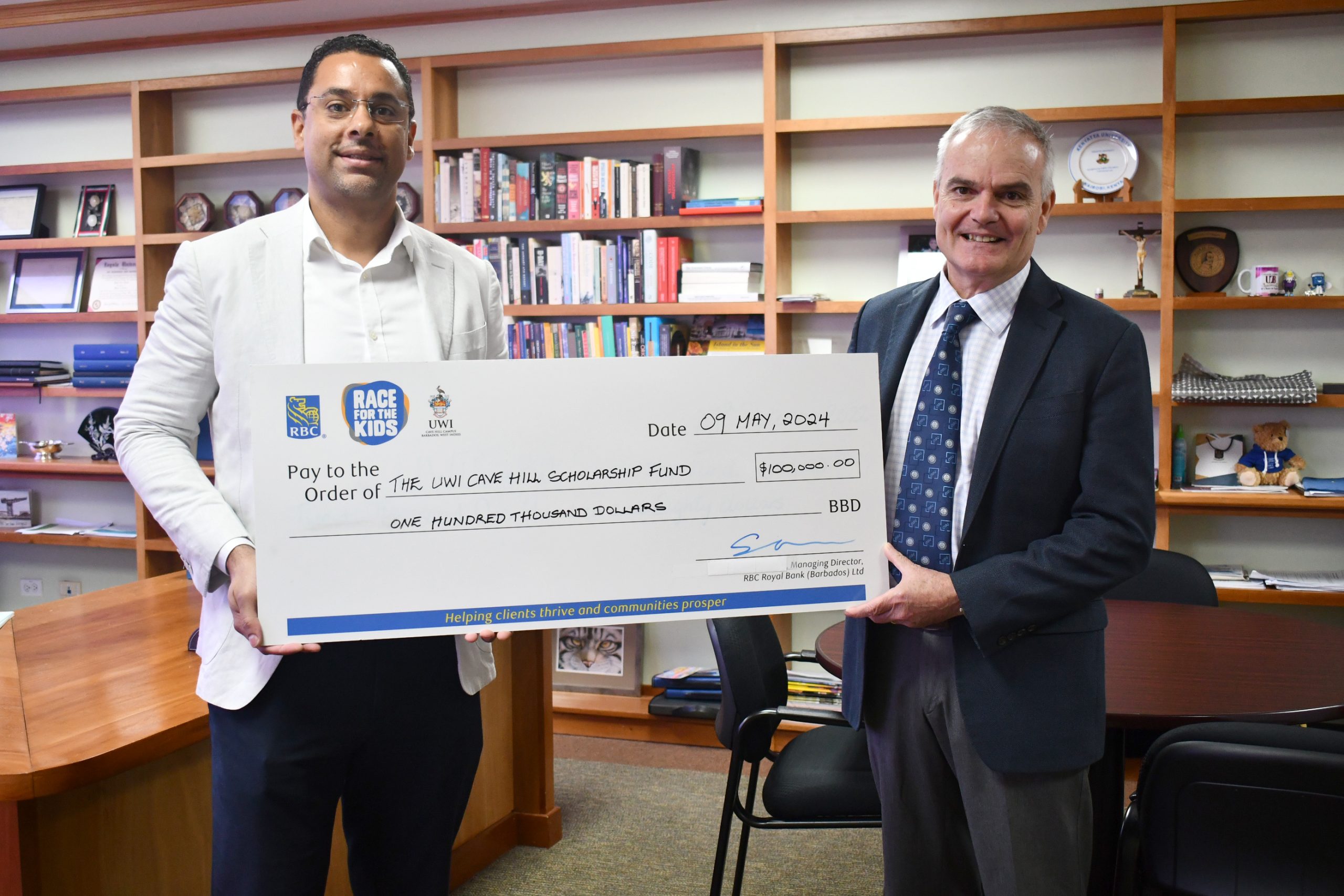 RBC Managing Director and Area Vice President of Banking, Shimon McIntosh, (left) presenting the $100,000 cheque to Principal of The UWI Cave Hill Campus, Professor Clive Landis.